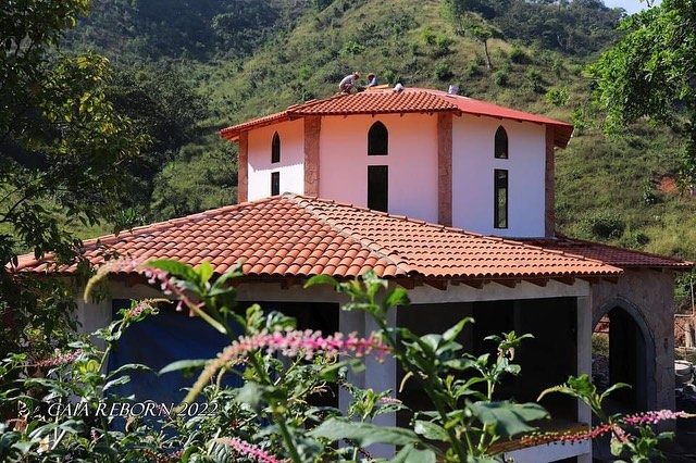 One of the finished houses with tiled roof and arched windows