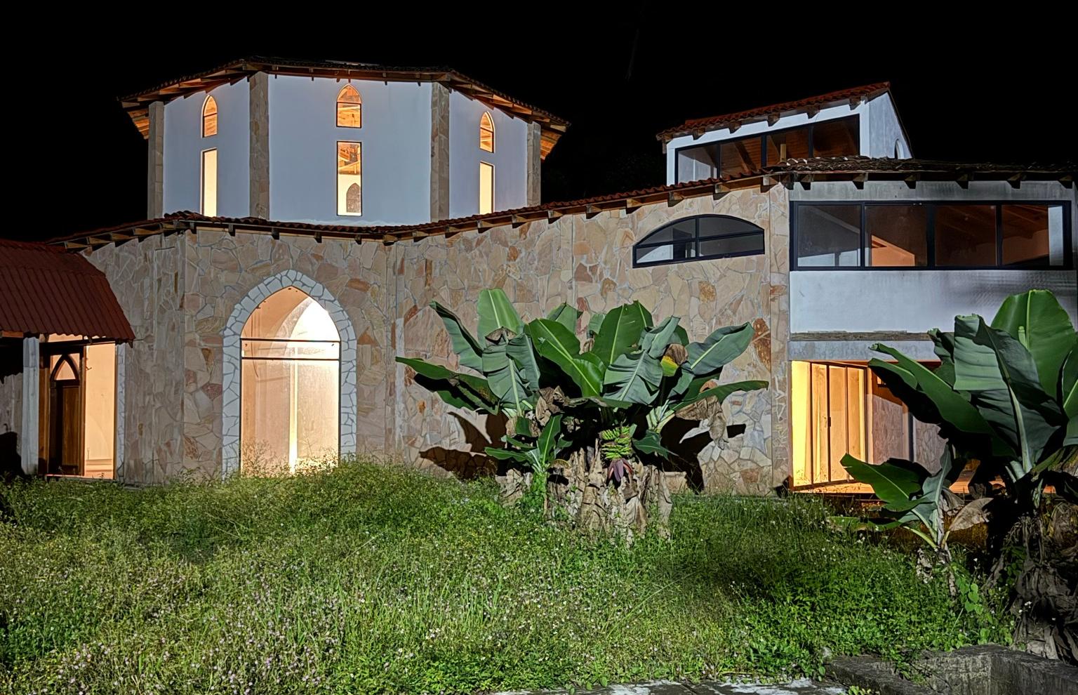 The Gaia Reborn center lit up at night